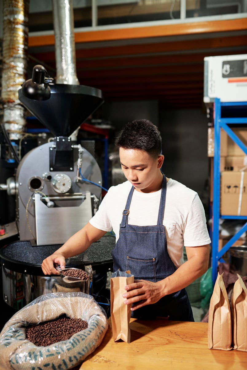 Man Putting Roasted Coffee in Packages