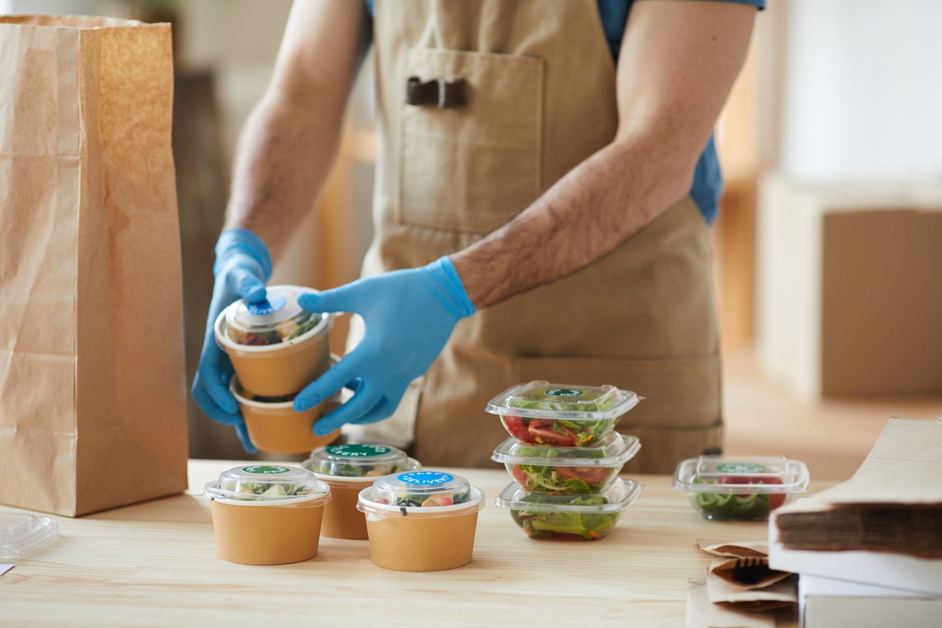 Worker with Gloves Preparing Food for Delivery